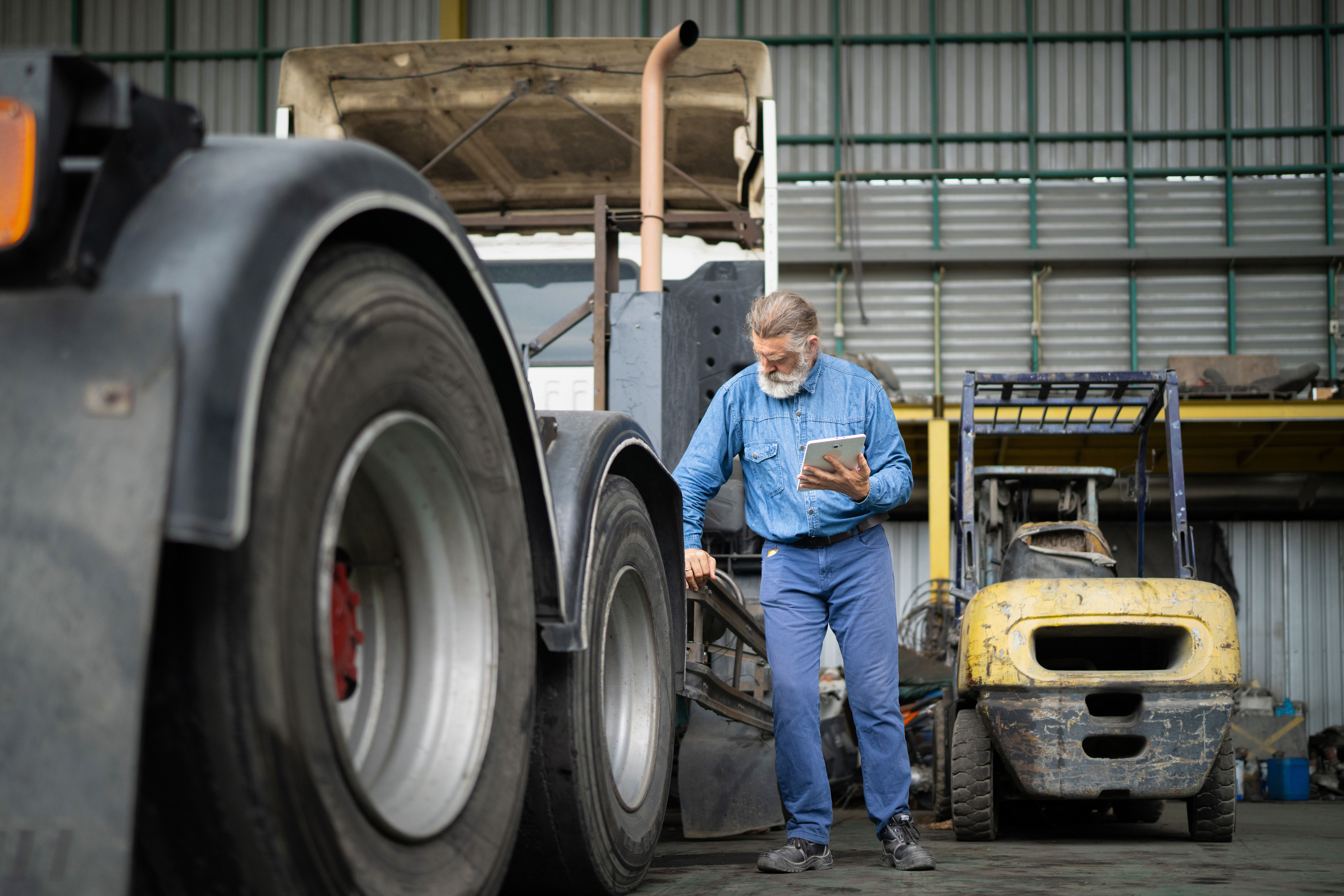 Mechanic checklist truck engine in service station, Automotive technician works, maintenance, repair, labor, skill, safety, expertise, diligence.